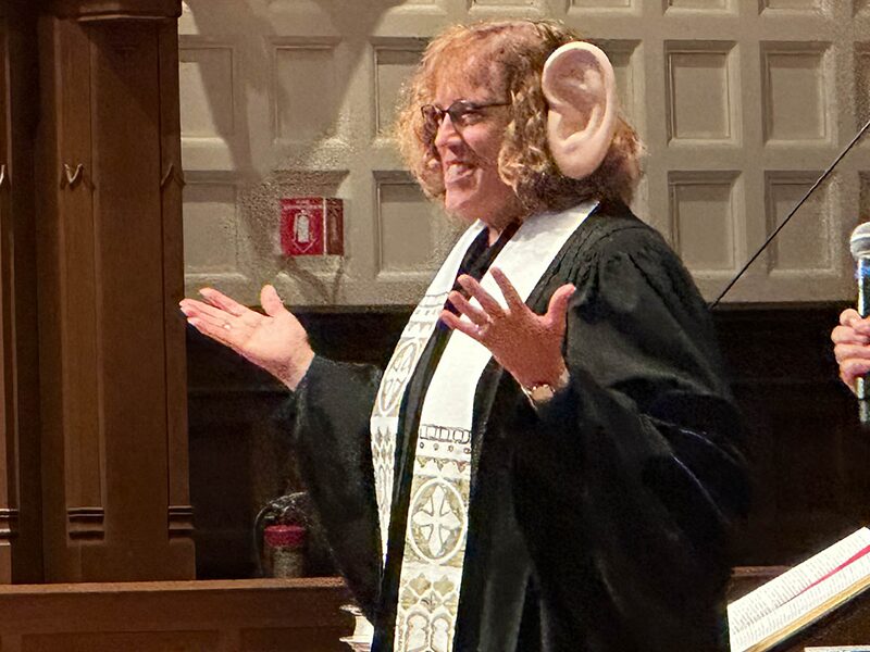 Female pastor wearing large ears to represent her willingness to listen.